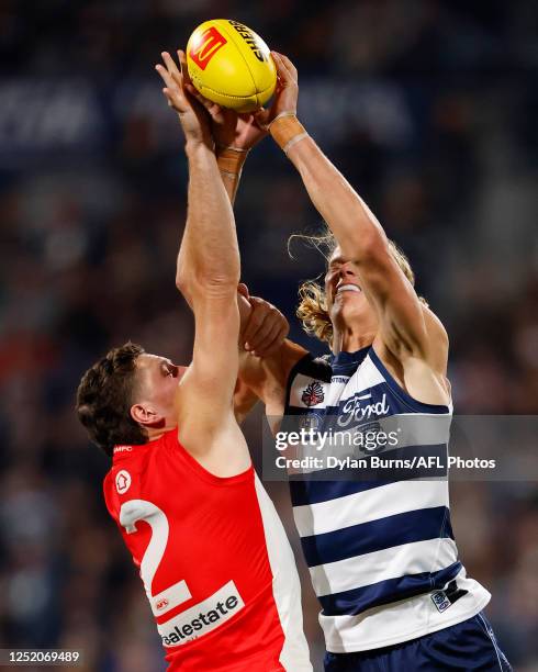 Hayden McLean of the Swans and Sam De Koning of the Cats compete for the ball during the 2023 AFL Round 06 match between the Geelong Cats and the...