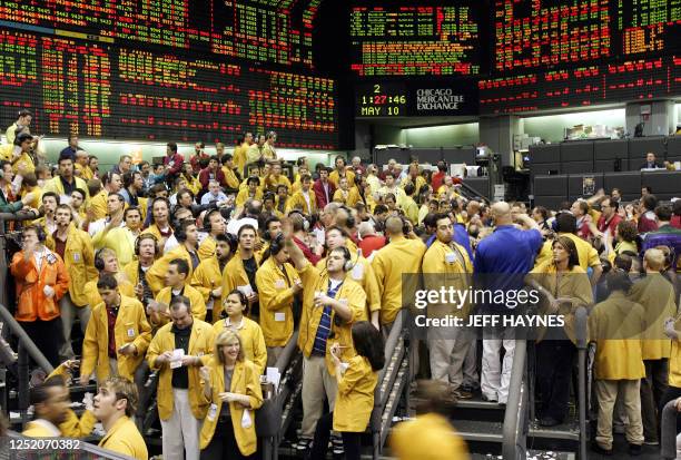 Traders and clerks signal prices in the Eurodollar pit 10 May 2006 at the Chicago Mercantile Exchange, in Chicago, Illinois, following the...