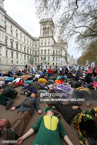 Protesters take part a mass 'die-in' outside of the Treasury Offices during a demonstration by the climate change protest group Extinction Rebellion,...