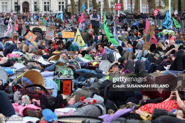 Protesters take part a mass 'die-in' outside of the Treasury Offices during a demonstration by the climate change protest group Extinction Rebellion,...