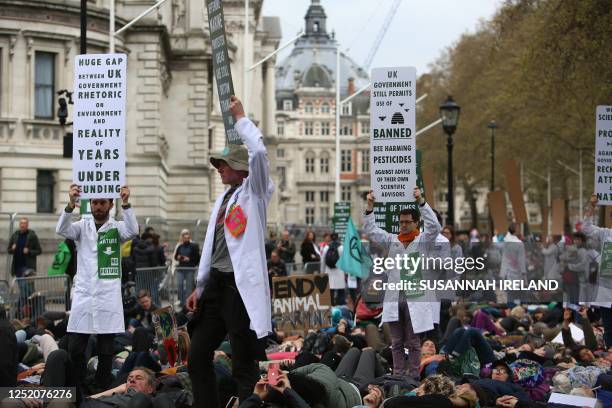 Protesters take part a mass 'die-in' outside of the Treasury Offices during a demonstration by the climate change protest group Extinction Rebellion,...