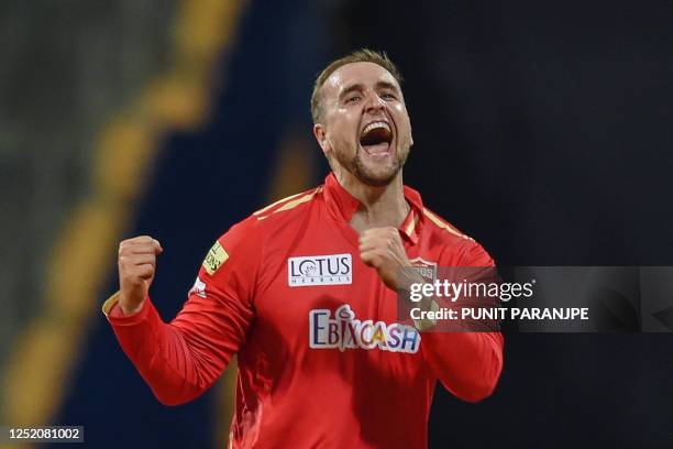 Punjab Kings' Liam Livingstone celebrates after taking the wicket of Mumbai Indians' Rohit Sharma during the Indian Premier League Twenty20 cricket...