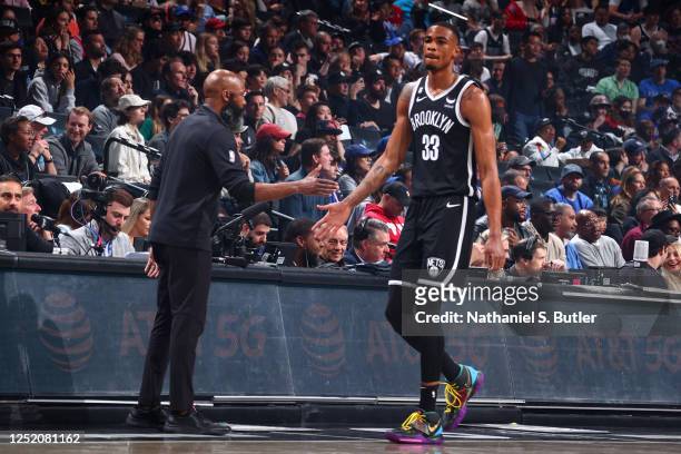 Nicolas Claxton of the Brooklyn Nets high fives Head Coach Jacque Vaughn of the Brooklyn Nets during the game against the Philadelphia 76ers during...