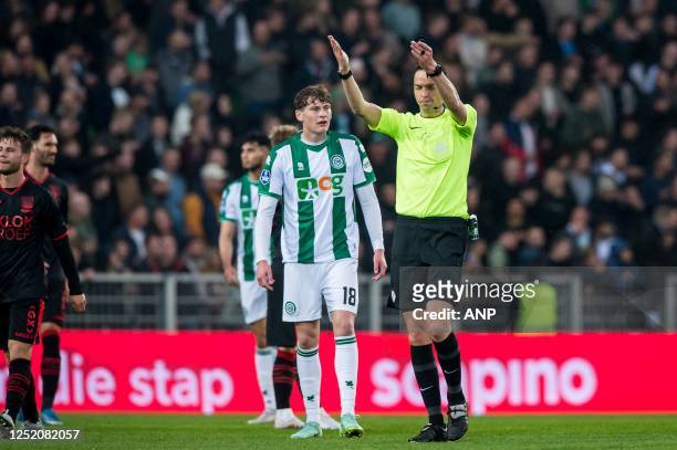 Referee Richard Martens decides to leave the field as supporters throw beer during the Dutch premier league match between FC Groningen and NEC at the...