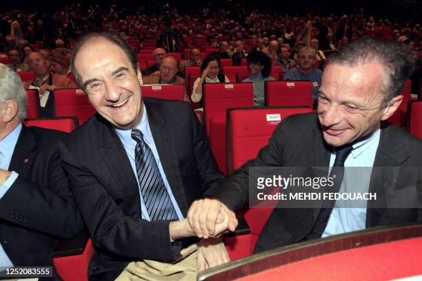 Former French TV Canal Plus president Pierre Lescure jokes with chairman and chief executive officer of Veolia Environnement, Henri Proglio, during...