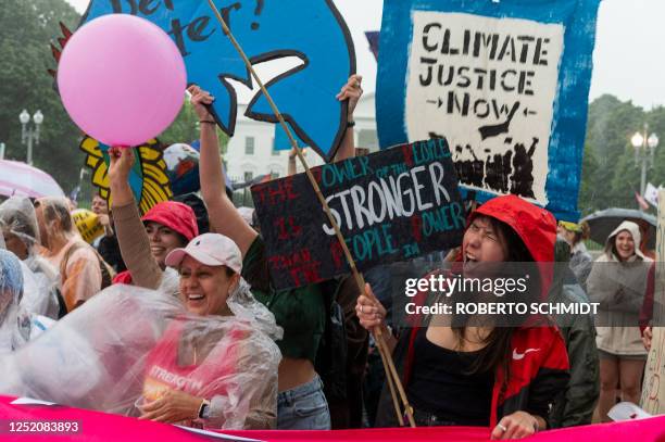 Environmental activists protest during the "End the Era of Fossil Fuels" rally on Earth Day, in front of the White House in Washington, DC, on April...