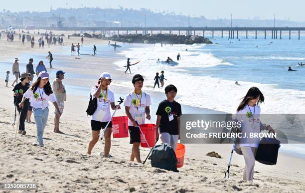 Youth group participate in cleaning up trash at Venice Beach for Earth Day on April 22 in Los Angeles, California. Beach and river cleanups are being...