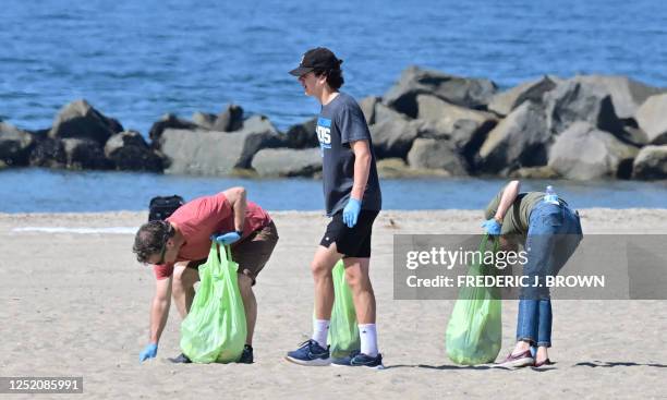 People help pick up trash at Venice Beach for Earth Day on April 22 in Los Angeles, California. Beach and river cleanups are being held across...