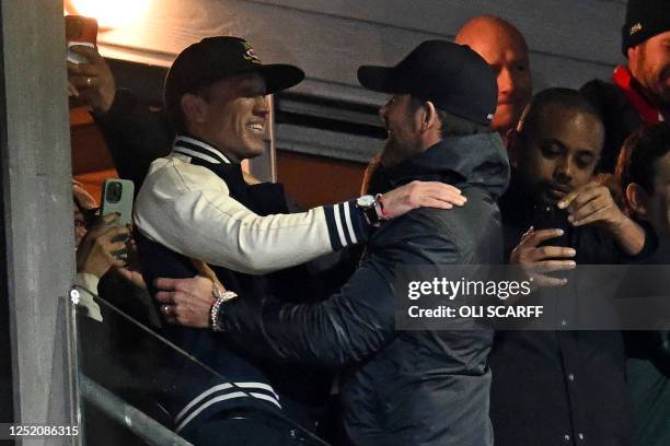 Actor and Wrexham owner Rob McElhenney and US actor and Wrexham owner Ryan Reynolds celebrate on the final whistle in the English National League...