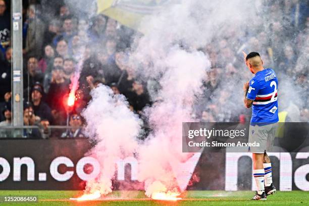 Bruno Amione of Sampdoria protects himself as fans of Sampdoria throw some smoke-bombs onto the pitch during the Serie A match between UC Sampdoria...