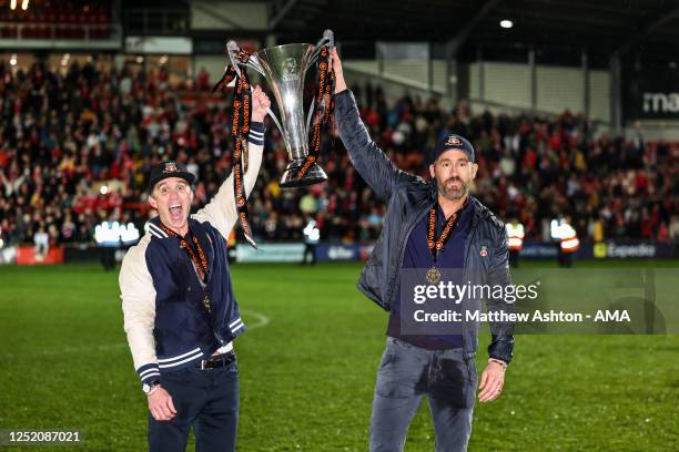 Ryan Reynolds co-owner of Wrexham and Rob McElhenney co-owner of Wrexham with the Vanarama National League Trophy as Wrexham celebrate promotion back...