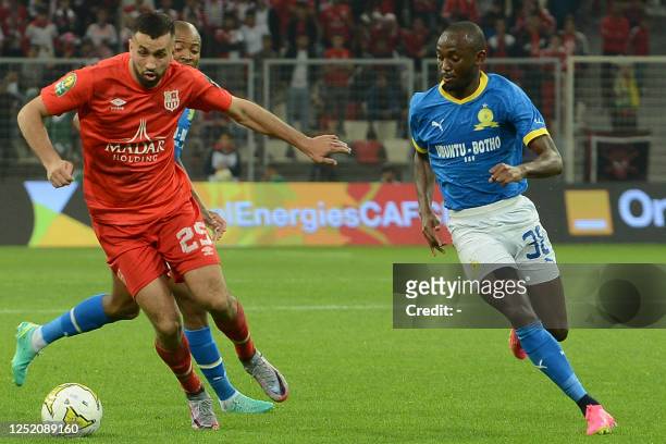 Belouizdad's Algerian defender Miloud Rebiai is marked by Sundowns' Namibian forward Peter Shalulile during the CAF Champions League quarter-final...