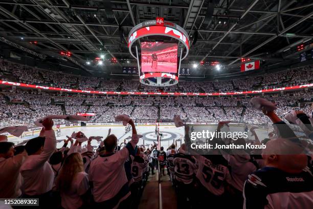 Fans wave white towels during the singing of 'O Canada' prior to puck drop between the Winnipeg Jets and the Vegas Golden Knights in Game Three of...