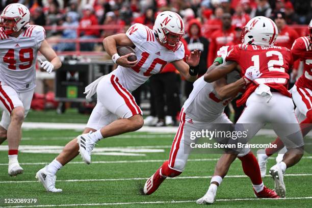 Quarterback Heinrich Haarberg of Nebraska Cornhuskers runs against defensive back Omar Brown at Memorial Stadium on April 22, 2023 in Lincoln,...