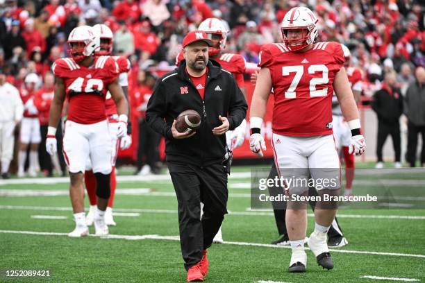 Head coach Matt Rhule of Nebraska Cornhuskers walks off the field with lineman Nash Hutmacher of Nebraska Cornhuskers after the first play to hand...