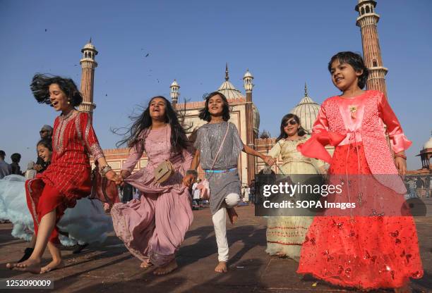 Muslim kids seen playing after offering Eid al-Fitr prayers at the historical mosque Jama Masjid in New Delhi. Muslims around the world celebrating...