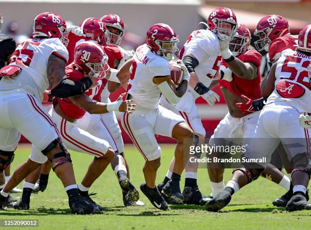 Jase McClellan of the White Team bust through the line of the Crimson Team defense during the first half of the Alabama Spring Football Game at...