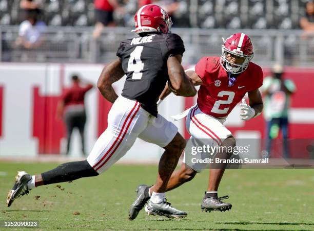 Caleb Downs of the of the Crimson Team looks to bring down Jalen Milroe of the White Team during the second half of Alabama Spring Football Game at...