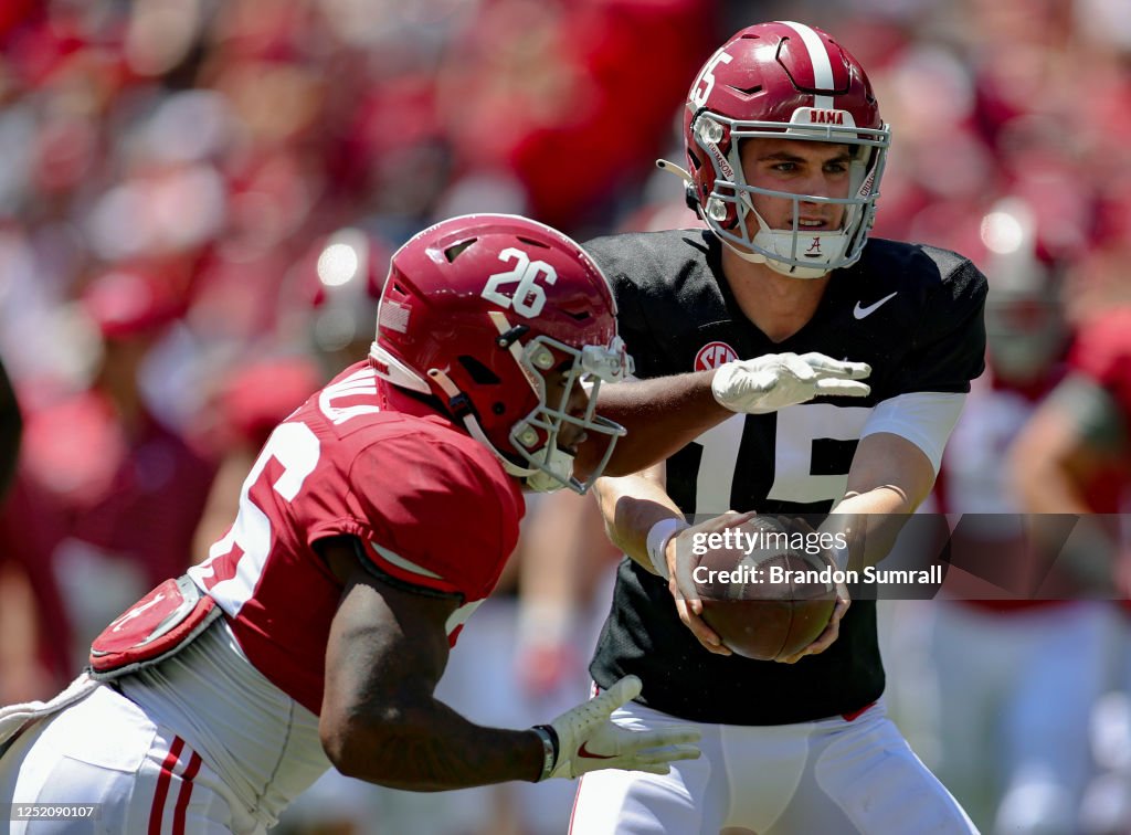 Ty Simpson hands off to Jamarion Miller of the Crimson Team during