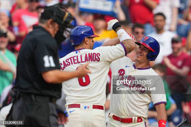 Nick Castellanos of the Philadelphia Phillies celebrates with J.T. Realmuto after hitting a solo home run in the bottom of the sixth inning against...