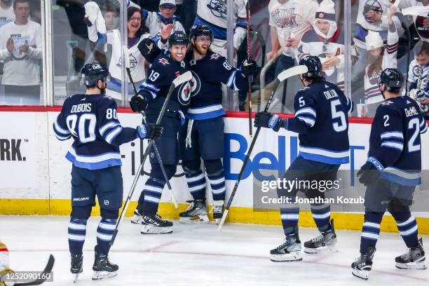 Pierre-Luc Dubois, David Gustafsson, Kyle Connor, Brenden Dillon and Dylan DeMelo of the Winnipeg Jets celebrate a first period goal against the...