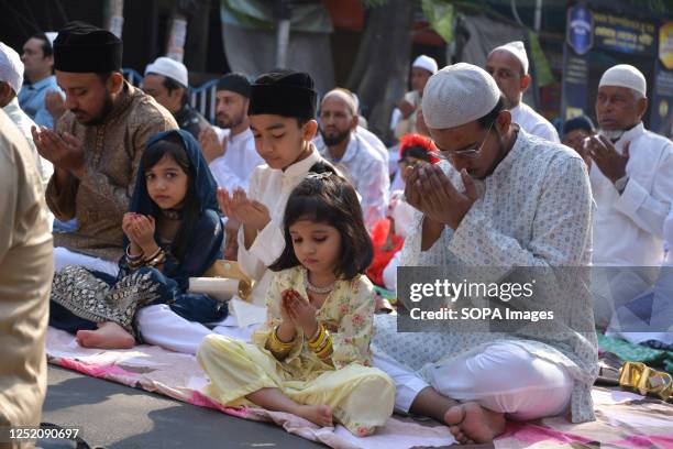 Two small girls offer prayers during the special prayer on the occasion of Eid-Ul-Fitr. Eid-Ul-Fitr is a Muslim festival of happiness celebrated all...