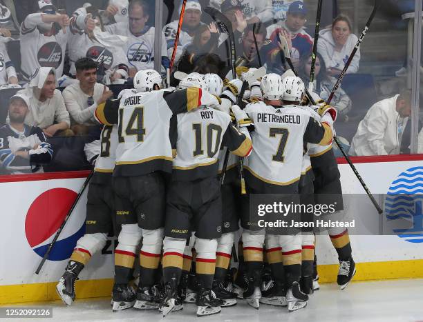 Vegas Golden Knights players celebrate after defeating the Winnipeg Jets in the second overtime period of Game Three of the First Round of the 2023...