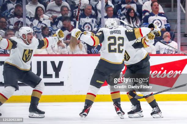 Ivan Barbashev, Michael Amadio and Brett Howden of the Vegas Golden Knights celebrate after scoring the winning goal against the Winnipeg Jets in...