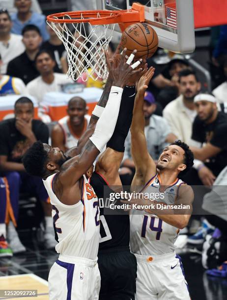 Russell Westbrook of the Los Angeles Clippers is double teamed by Landry Shamet and Deandre Ayton of the Phoenix Suns during the first half of Round...