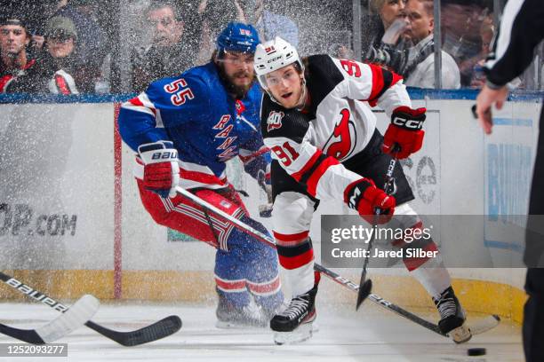 Dawson Mercer of the New Jersey Devils skates with the puck against Ryan Lindgren of the New York Rangers in Game Three of the First Round of the...