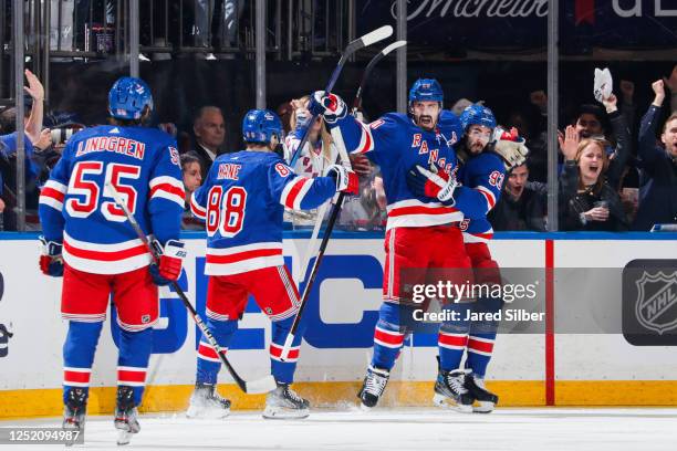 Chris Kreider of the New York Rangers celebrates with teammates after scoring a goal in the second period against the New Jersey Devils in Game Three...