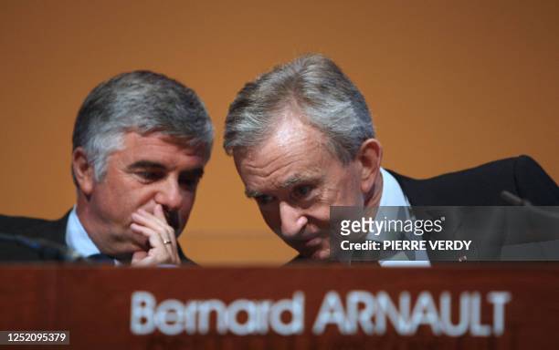 French luxury goods group LVMH chairman Bernard Arnault chats with his general director Antonio Belloni during the group presentation of 2008...
