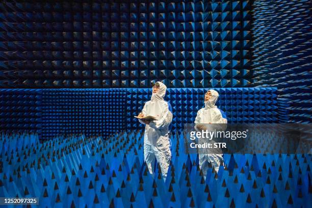 This photo taken on April 20, 2023 shows technicians conducting tests on new materials products at a research laboratory of the Ningbo Shuxiang New...