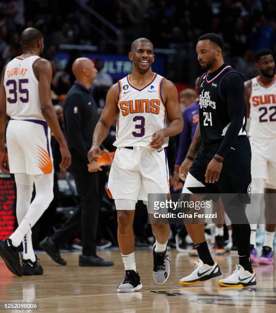 Phoenix Suns guard Chris Paul grins after sinking a late game 3-pointer as LA Clippers guard Norman Powell looks straight ahead in Game 4 of the...