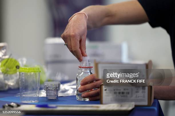 An attendee handles the sampling equipment during a training for doping controllers who came to train for the Paris Olympic and Paralympic Games in...