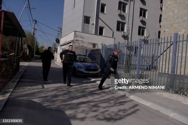 Kosovo police officers patrol near a polling station in the north of Mitrovica, predominantly populated by the ethnic Serb minority amid the...
