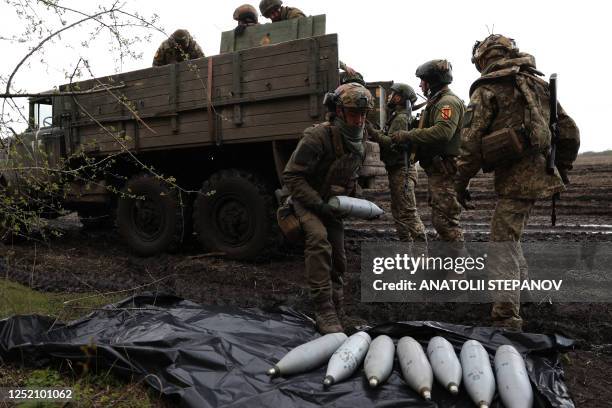 Ukrainian artillerymen of the Aidar battalion work with artillery shells on a front line position near Bakhmut, Donetsk region, on April 22 amid the...