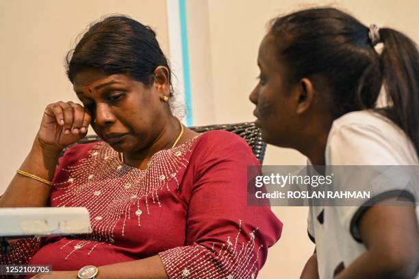 Leelavathy Suppiah , sister of a convicted drug trafficker Tangaraju Suppiah, who is scheduled for execution, reacts during a press conference in...