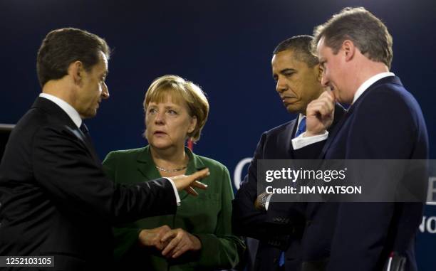 French President Nicolas Sarkozy talks with German Chancellor Angela Merkel , US President Barack Obama and British Prime Minister David Cameron...