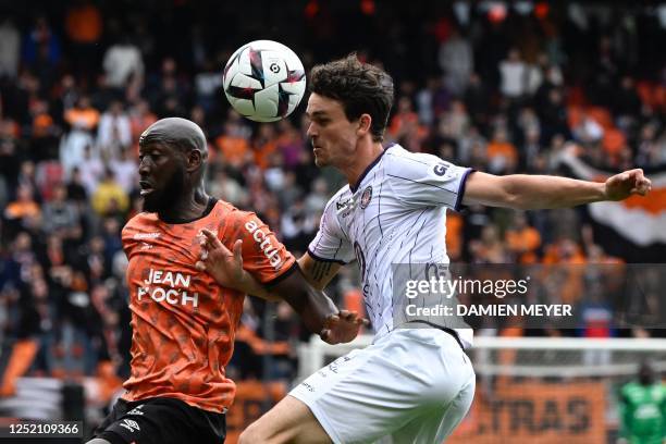 Lorient's Malian forward Ibrahima Kone fights for the ball with Toulouse's Danish defender Rasmus Nicolaisen during the French L1 football match...