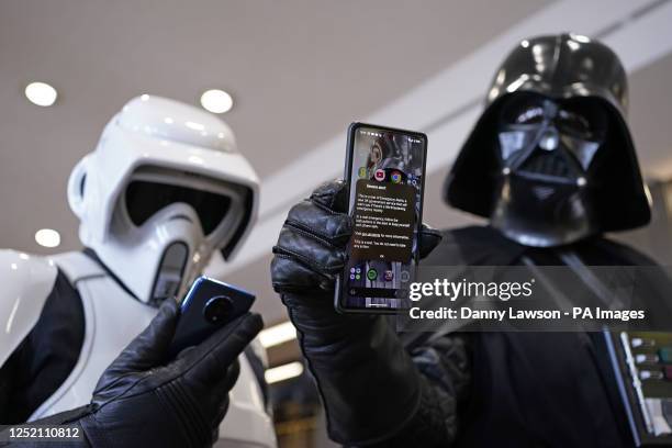 Cosplayer dressed as Darth Vader and a cosplayer dressed as a Stormtrooper with their mobile phones during a test of a new emergency public alert...
