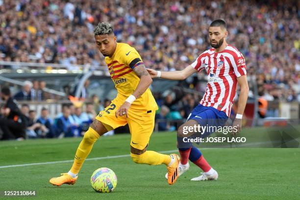 Barcelona's Brazilian forward Raphinha vies with Atletico Madrid's Belgian midfielder Yannick Ferreira-Carrasco during the Spanish league football...