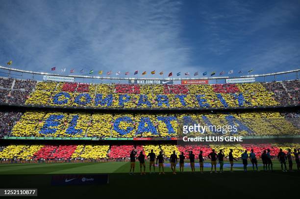 Barcelona's supporters cheer prior the Spanish league football match between FC Barcelona and Club Atletico de Madrid at the Camp Nou stadium in...