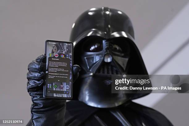 Cosplayer dressed as Darth Vader with his mobile phone during a test of a new emergency public alert system during the Sci Fi Scarborough at The Spa...