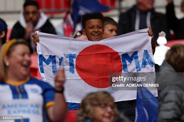 Brighton fan holds up a Japanese flag in honour of Brighton's Japanese midfielder Kaoru Mitoma in th crowd ahead of the English FA Cup semi-final...