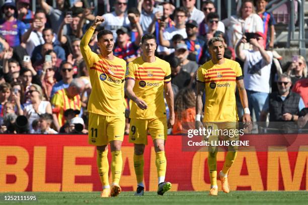 Barcelona's Spanish forward Ferran Torres celebrates scoring his team's first goal with Barcelona's Polish forward Robert Lewandowski and Barcelona's...