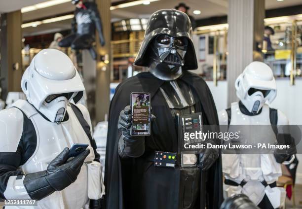 Members of the Sentinel Squad UK dressed as Darth Vader and Stormtroopers with their mobile phones during a test of a new emergency public alert...
