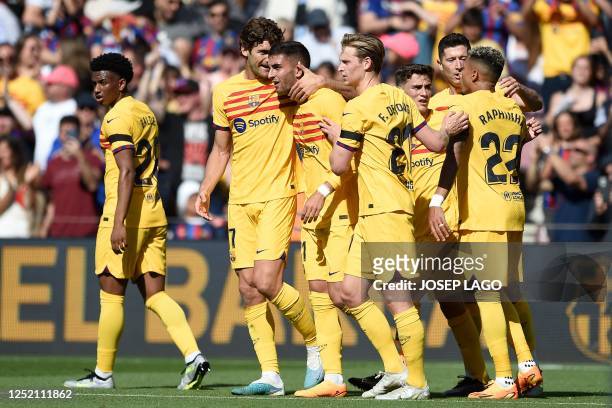 Barcelona's Spanish forward Ferran Torres celebrates with teammates scoring his team's first goal during the Spanish league football match between FC...