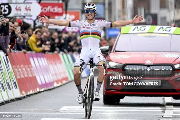 Soudal Quick-Step's Belgian rider Remco Evenepoel celebrates as he cycles to the finish line to win the men's elite race of the Liege-Bastogne-Liege...