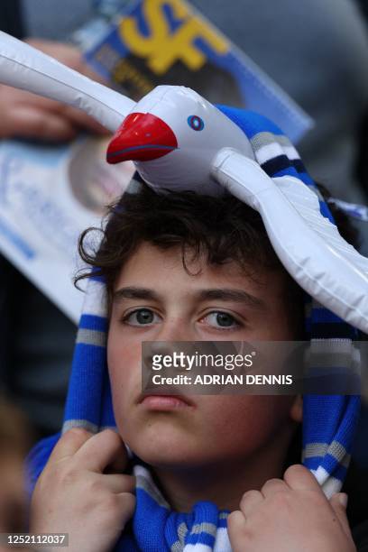 Brighton fan wears an inflatable 'seagull' on his head in the crowd ahead of the English FA Cup semi-final football match between Manchester United...